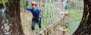 Participant smiling after crossing adventure element