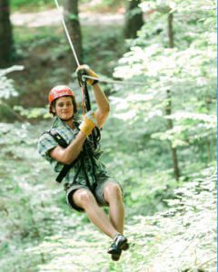 Man ziplines at Treetop Zipline Adventure in Knoxville